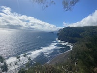 a view of the ocean from a cliff overlooking a black sand beach