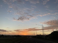 a car driving down a highway at sunset